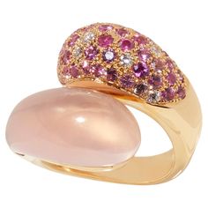 One-of-a-kind Design in Pink Gold with Rose Quartz, Diamonds, and Pink Sapphires The ring crafted in 18 karat pink gold features a unique design known as ‘wokkel’ in Dutch. The rose quartz gemstone is sculpted into a rounded shape that complements the mix of diamonds and various hues of pink sapphire, creating a soft and elegant piece that wraps beautifully around the fingers. The blue version of this ring, made in 18 karat white gold and adorned with blue topaz, sapphires, and diamonds, has alr Luxury Pink Cabochon Ring, Luxury Multi-stone Rose Gold Ring, Elegant Pink Multi-stone Rings, Formal Pink Rings With Polished Finish, Luxury Pink Gold Ring With Pink Sapphire, Fine Jewelry Pink Rings With Polished Finish, Pink Rings With Polished Finish Fine Jewelry, Luxury Pink Rings With Pave Setting, Luxury Pink Rings Hallmarked