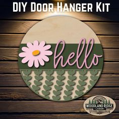 the diy door hanger kit is made with wood and has pink flowers on it