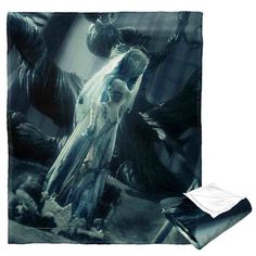 a blanket with an image of a woman standing in front of two giant black monsters