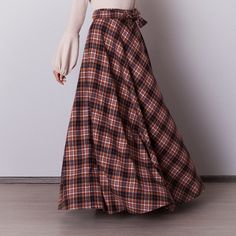 Brown plaid skirt: - Side seam pockets - Hidden zipper in the side seam - Separate sash - Classic tartan pattern - Fabric is 60% wool, 39% polyviscose, 1% of elastane Model is 6'2'', she wears US 8 size US 0  Bust 82 cm (32.5 inches) Waist 64 cm (25 inches) Hips 89 cm (35 inches) US 2  Bust 85 cm (33.5 inches) Waist 66 cm (26 inches) Hips 92 cm (36 inches) US 4  Bust 88 cm (34.5 inches) Waist 68 cm (27 inches) Hips 94 cm (37 inches)  US 6  Bust 90 cm (35.5 inches) Waist 71 cm (28 inches) Hips 96 cm (38 inches)  US 8  Bust 93 cm (36.5 inches) Waist 74 cm (29 inches) Hips 99 cm (39 inches) US 10  Bust 95 cm (37.5 inches) Waist 76 cm (30 inches) Hips 102 cm (40 inches) US 12  Bust 99 cm (39 inches) Waist 80 cm (31.5 inches) Hips 105 cm (41.5 inches) US 14  Bust 103 cm (40.5 inches) Waist 84 c Plaid Skirted Bottoms For Fall, Plaid Relaxed Fit Skirt For Fall, Plaid Skirt With Pockets For Winter, Brown Maxi Skirt With Pockets For Fall, Long Plaid Skirt For Fall, Plaid Long Skirt For Fall, Relaxed Plaid Skirt For Fall, Plaid Skirt With Pockets, Scottish Style Plaid Skirt For Fall