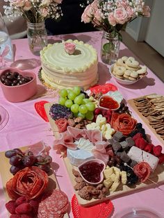 a table filled with lots of food and desserts on top of wooden trays