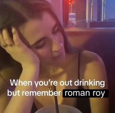 a woman sitting at a table with a drink in front of her and the words when you're out drinking, but remember roman rov