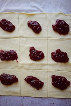 several squares of dough with jam on them