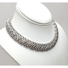 This is part of Chairish’s Costume Jewelry assortment.  1960s rhodium plated textured openwork articulated collar necklace with hook clasp. Marked "Monet" on a hangtag and "©" on the opposite side of the tag. Measures: 5 1/4 inches by 5 1/4 inches. Interior circumference on the largest setting is about 15 inches. Condition: Very good; it may have originally had a dangle at the end of the extension chain. Elegant Metal Choker With Oxidized Finish, Silver Metal Formal Choker, Formal Silver Metal Choker, Formal Round Metal Choker, Vintage Silver Choker With Intricate Design, Silver Vintage Choker With Intricate Design, Elegant Silver Choker With Intricate Design, Formal Metal Necklace With Oxidized Finish, Formal Oxidized Metal Necklace