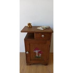 a small wooden cabinet with a mushroom on it