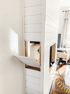 an unfinished room with white walls and wood flooring