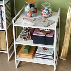 a shelf filled with books and craft supplies