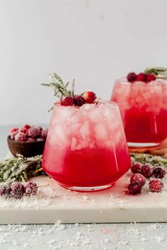 two glasses filled with ice and cranberry punch