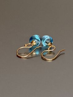 Beautiful genuine blue topaz earrings. The smooth blue topaz acorns have a beautiful clear sky blue color and are flawless. The AAA grade inverted drops attached to a 14k solid gold round caps, as they dangle from the 14k solid gold gold ear wires. They are stunning elegant and perfect for everyday wear. Quality: AAA Quality hanf polish genuine blue topaz acorns *The dimension of stones is about 112x8 mm *Metal: 14K SOLID GOLD *Earrings drop length (ear wires including the stones): 26 mm/ 1 inch Hypoallergenic Blue Briolette Earrings, London Blue Topaz Earrings, December Birthday Gifts, Blue Topaz Jewelry, December Birthday, Topaz Jewelry, Luxury Earrings, Blue Topaz Earrings, Solid Gold Earrings