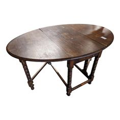 an oval wooden table with two legs