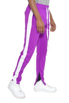 Single Stripe Track Pants Standard Pockets, Single Back Pocket Elastic Waist and Drawstring Ankle Zipper 95 Polyester 5 Spandex Model is 5'11 wearing a Large, 34" Sportswear Bottoms With Side Stripes And Stretch, Stretch Sportswear Bottoms With Side Stripes, Fitted Sporty Joggers, Sporty Fitted Jogger Pants, Sporty Purple Sweatpants For Spring, Fitted Jogging Pants, Jogging Bottoms With Side Stripes, Fitted Full Length Jogging Pants, Fitted Full-length Jogging Pants