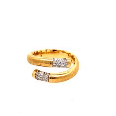 an open gold ring with two diamonds on it