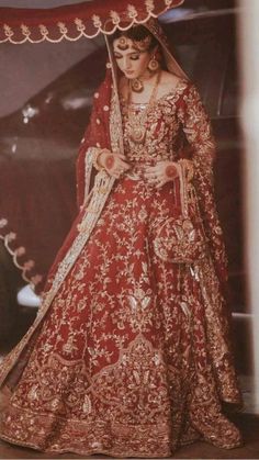 a woman in a red and gold wedding dress