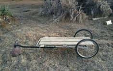 a wooden cart sitting in the middle of a field