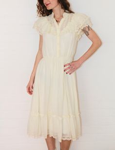 The most amazing vintage 1970s 'Candi Jones' ivory prairie frilled lace dress. So very sad this one doesn't fit me 😥 In excellent vintage condition.  Material: cotton/lace    Size: 6-8 Australian  Measurements  Length: 142cm Armpit to Armpit: 45cm Waist: 64-88cm Follow us on Instagram @cultofvtg Prairie Dress With Ruffles For Daywear, Daywear Prairie Dress With Ruffles, Ruffled Prairie Dress For Daywear, Prairie Daywear Dresses With Ruffles, Prairie Style Ruffled Dresses For Daywear, Prairie Style Ruffle Dresses For Daywear, Prairie Ruffle Dress For Daywear, Vintage Swiss Dot Dress For Spring, Vintage Swiss Dot Dresses For Spring