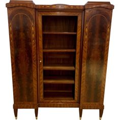 an antique wooden cabinet with glass doors