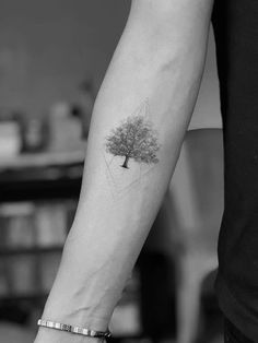 a person with a tree tattoo on their arm