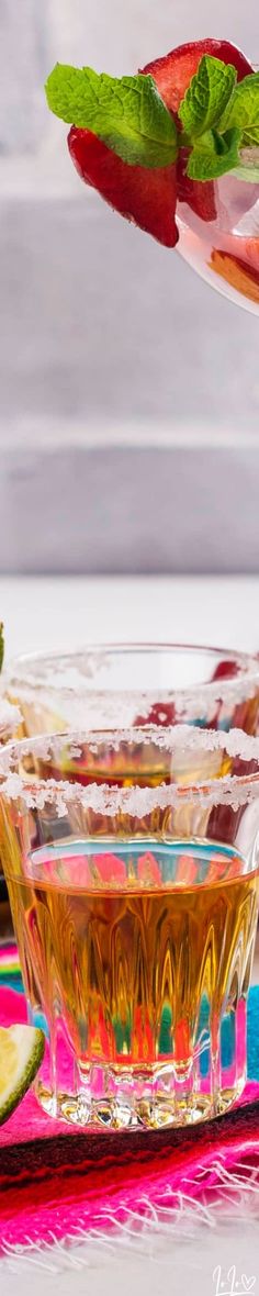 a glass bowl filled with liquid and garnished with mint