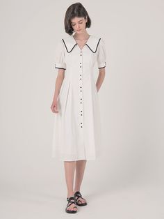 Editor's Notes Highlighted with the contrasting white on black outlines and buttons  this cotton dress has exaggerated collars that is balanced by a nipped-in waist.- Shirt-dress with two-button patterns down the front and on the sleeve-ends- Deep V-neckline with large collars that fall to the back as well- Puffed sleeves- Front and back nipped-in waist- Flared silhouetteMeasurements(in.)S / M- Length: 44.09 in. / 44.88 in. - Shoulder: 13.39 in. / 13.78 in. - Bust: 37.40 in. / 38. Elegant Daywear Dress With Striped Collar, Elegant Dresses With Striped Collar For Daywear, Classic White A-line Shirt Dress, Classic White Cotton Midi Dress, Classic Workwear Dress With Striped Collar, White Cotton Dresses With Placket, Cotton Short Sleeve Dress With Striped Collar, White Collared Daywear Dress, White Collared Dress For Daywear