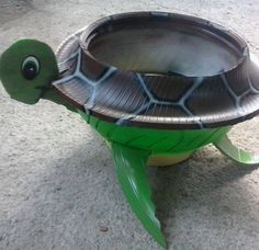 a paper plate turtle that is sitting on the ground