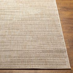 a beige rug on top of a wooden floor