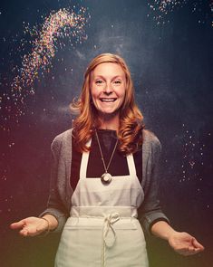 a woman wearing an apron and holding out her hands in front of confetti sprinkles