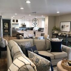 a living room filled with lots of furniture and decor on top of a hard wood floor