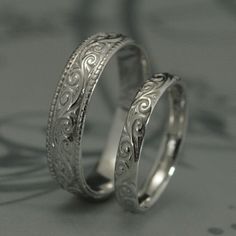 This is a wonderfully lovely set for a wonderfully lovely couple! It features a vintage style design with a modern twist to it. Cast in solid 14K gold, it features a swirling design around the entire outer surface. The wider band measures 5.5mm wide by 1.5mm thick. It features a lovely milgrain edge. The thinner band measures 3.5mm wide by 1.5mm thick and features the matching design without the edge. These are quality solid gold rings to last you a lifetime and then some! Your rings can be cast Yellow Gold Wedding Rings With Intricate Design, White Sterling Silver Engraved Wedding Ring, 14k Gold Engraved Wedding Ring With Intricate Design, 14k Gold Engraved Ring With Intricate Design For Wedding, Wedding Engraved Ring With Intricate Design In 14k Gold, 14k Gold Wedding Jewelry With Intricate Design, Wedding Jewelry With Intricate Design In 14k Gold, Gold Sterling Silver Couple Rings For Wedding, 14k Gold Jewelry With Intricate Design For Wedding