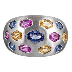 Satin-finished 18 karat white gold displays oval faceted sapphires of blues, pinks and yellows in hexagonal bezels. This piece is unusual and beautiful with the ideal balance of playfulness and sophistication. The sapphires weigh 3.78 carats in total. Size 6.25 can be resized on request. Ring Blue Sapphire, Dome Ring, Purple Sapphire, Ring Blue, Domed Ring, Platinum Ring, Yellow Sapphire, Natural Sapphire, Princess Cut Diamonds