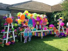 an outdoor party with balloons and decorations