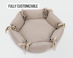 a dog bed with bows on the front and back sides, made out of linen