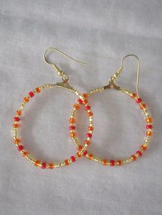 Warm coloured hoop earrings The hoops face the front Hoops are approx. 3 cm in diameter Adjustable Orange Hoop Earrings, Orange Small Hoop Earrings For Gift, Small Hoop Earrings Orange Gift, Small Hoop Earrings Orange For Gift, Small Hoop Earrings In Orange For Gifts, Red Small Hoop Earrings, Orange Small Hoop Earrings With Ear Wire, Orange Hoop Beaded Earrings As Gift, Jewelry Earrings Hoops