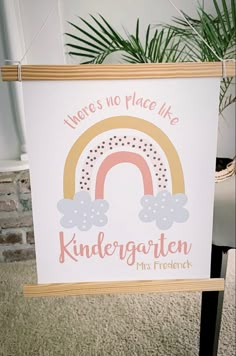 a sign that says there's no place like kindergarten with a rainbow