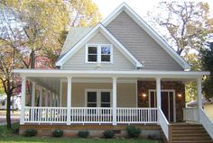 a small house with porches and white railings