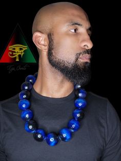 This handsome and eye catching piece is hand crafted and created by Eye Create LLC.  This item is stained in a beautiful custom made deep and vibrant royal blue. All stains are made by our company. All beads are solid and hand drilled by yours truly. These beads are highly glossed and stands out like no other!  The necklace can be purchased individually or as a set with the matching bracelet.   The bracelet is made from natural Blue Tiger eye, Black Obsidian, and Hematite gem beads.    Please fo Artisan Blue Wooden Beads, Unique Blue Wooden Beads, Blue Wooden Beads Jewelry For Jewelry Making, Traditional Blue Jewelry With Wooden Beads, Blue Wooden Beads, Blue Wooden Beads Round Jewelry, Blue Jewelry With Round Black Beads, Blue Wooden Round Beads Jewelry, Blue Spiritual Necklaces With Large Beads