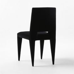 a black chair sitting on top of a white floor