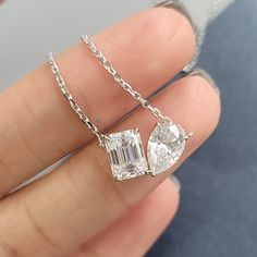 Product: 14K Solid Gold / White Gold 1.5 Carat Pear Cut With 2.0 Carat Emerald Cut Moissanite Diamond Toi Et Moi (aka 'You and I', en français s'il vous plaît)  Pendant Necklace Metal: 14K Solid Gold / 14K Solid White Gold Weight: About 3.43G Stone Weight:  Pear Cut 6X9mm 1.5ct  Emerald Cut 6X8mm 2ct  D Color Moissanite Stone with GRA certificate Chain: 16+1+1 Inches Dainty Chain Certificate:  Every Moissanite has individual number on it and come with same number certificate. Exclude 3mm Moissanite  Package: Elegant gift box is included. Jewelry makes a great gift for Mother's Day, Anniversary, Wedding, Birthday, Holiday, Christmas, Valentine's Day, Graduation Gift for Sister, Mother, Mom, Grandmother, Daughter, Wife, Girlfriend, Grandma, Female, Best Friend or it will be a good treat for Diamond Pendent Necklace, Graduation Gifts For Sister, Solitaire Pendant Necklace, Moissanite Necklace, Dainty Chain, Cz Necklace, Half Eternity Ring, Solitaire Pendant, Emerald Cut Diamonds