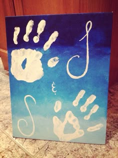 a hand and foot prints on a canvas