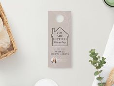 a door hanger with a house on it next to some towels and other items