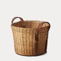 a wicker basket with brown leather handles