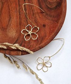 A delicate pair of hand made wire flower earrings on long, elegant, v shaped hooks Hand shaped from 0.8mm gold plated wire and gold hooks The flowers measure approx 2.5cm Super lightweight and easy to wear They would make a lovely little gift ALSO AVAILABLE IN SILVER All our orders are nestly giftwrapped and sent in ecofriendly packaging. A personalised note from the sender can be added to the order if you just let us know what your message is at the checkout    Visit us on Instagram www.instagram.com/lilbits.shop Minimalist Drop Earrings For Spring, Handmade Chic Flower Earrings, Dainty Flower Shaped Earrings For Spring, Dainty Flower-shaped Earrings For Spring, Dainty Flower Earrings For Spring, Minimalist Dangle Flower Earrings, Minimalist Flower Earrings With Ear Wire, Minimalist Flower-shaped Earrings, Handmade Gold Flower Earrings For Spring