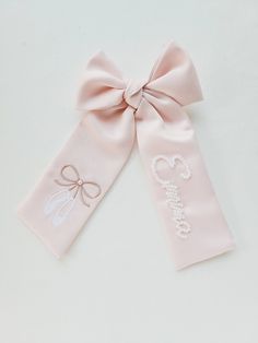 Light pink satin bow with ballerina shoes and name in pearls beaded by hand. Length: 9 inches Satin Products, Elegant Pink Bow With Ribbon, Pink Bow Nursery Theme, Baby Girl Pink Bow Nursery, Pink Bow Embroidery, Personalized Bow, Ballerina Party, Little Ballerina, Ballerina Birthday