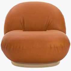 a brown leather chair sitting on top of a white floor