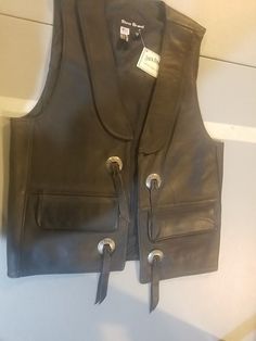 This stylish Jack Daniels leather vest is a must-have for any biker or Jack Daniel's enthusiast. Made from high-quality leather, this vest boasts a sleek black color. Available in size small, this vest is perfect for any man who wants to add a touch of edge to his outfit. The vest is designed with a regular fit and is ideal for layering over a t-shirt or long-sleeved shirt. It also has multiple pockets for storing essentials. Whether you're hitting the open road or just looking to add some attitude to your wardrobe, this steer brand vest is the perfect choice. Jack Daniels, Leather Vest, High Quality Leather, Vest Jacket, Long Sleeve Shirts, Mens Accessories, Shoe Accessories, Mens Outfits, Leather