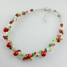 The crocheted wirng necklace is handmade using red coral, shells. Green is calming and refreshig, while red, the natural complement to green, add excitement and drama to the design. The Dimension of the necklace is 17-19 inches; 43-48cm. The length is well suited to crew and high necklines, but can equally add a frame to a plunging neckline. This length looks great with a tailored jacket. The crochet wiring is organic, airy and effortless. It is a perfect balance of intentional messiness, artist Green Beaded Necklace With Lobster Clasp As Gift, Handmade Red Coral Beaded Necklace For Wedding, Gift Beaded Necklace With Red Coral And Lobster Clasp, Handmade Red Coral Necklace For Weddings, Handmade Red Beaded Necklace For Gift, Handmade Red Beaded Necklace Gift, Handmade Green Necklace As A Gift For Her, Wire Wrapped Beaded Necklace Gift, Adjustable Red Necklace For Holiday