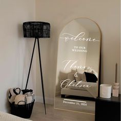 a mirror sitting on top of a wooden floor next to a basket