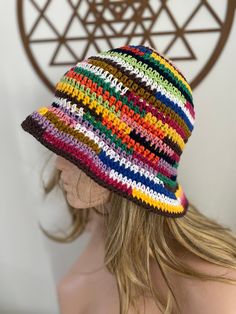 a woman wearing a multicolored crochet hat