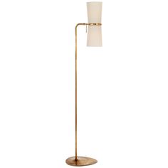 a floor lamp with a white shade on the top and a gold metal base,