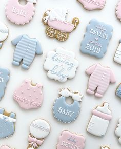 baby shower cookies are arranged on a white surface