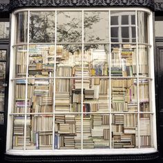 there is a window that has many books on it